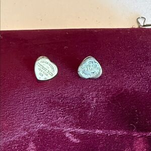 Tiffany & Co. Silver Heart Logo Stud Earrings on Burgundy